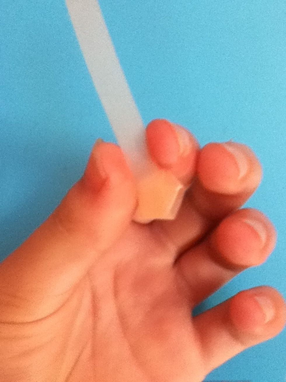 Fold the tail up to the left.