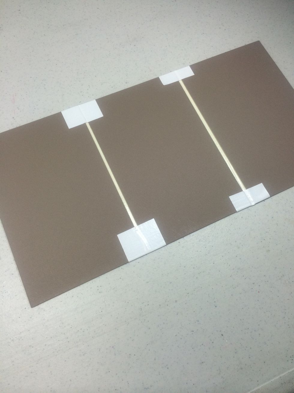 Fold the tape over as shown. This is the exterior of the folio. The smallest panel is now on the far left.