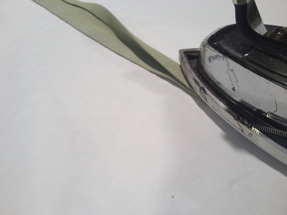 Fold the ties in half and press