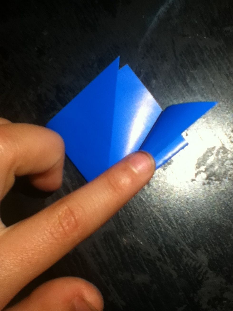 Fold the tip and edge of the flap you folded up outwards, so that i lines up with the diamond's edge that is already there.