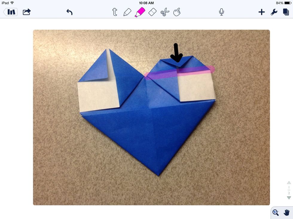 Fold the tip of the "ear" down to the horizontal line.