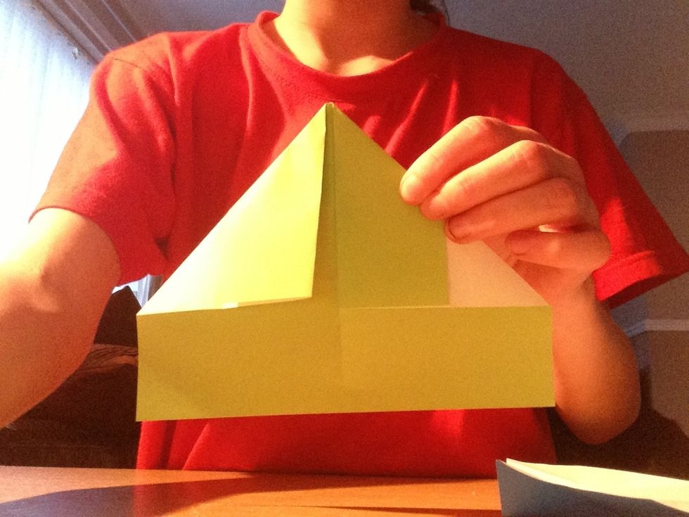 Fold the top 2 corners down into the centre as if you were making a paper airoplane