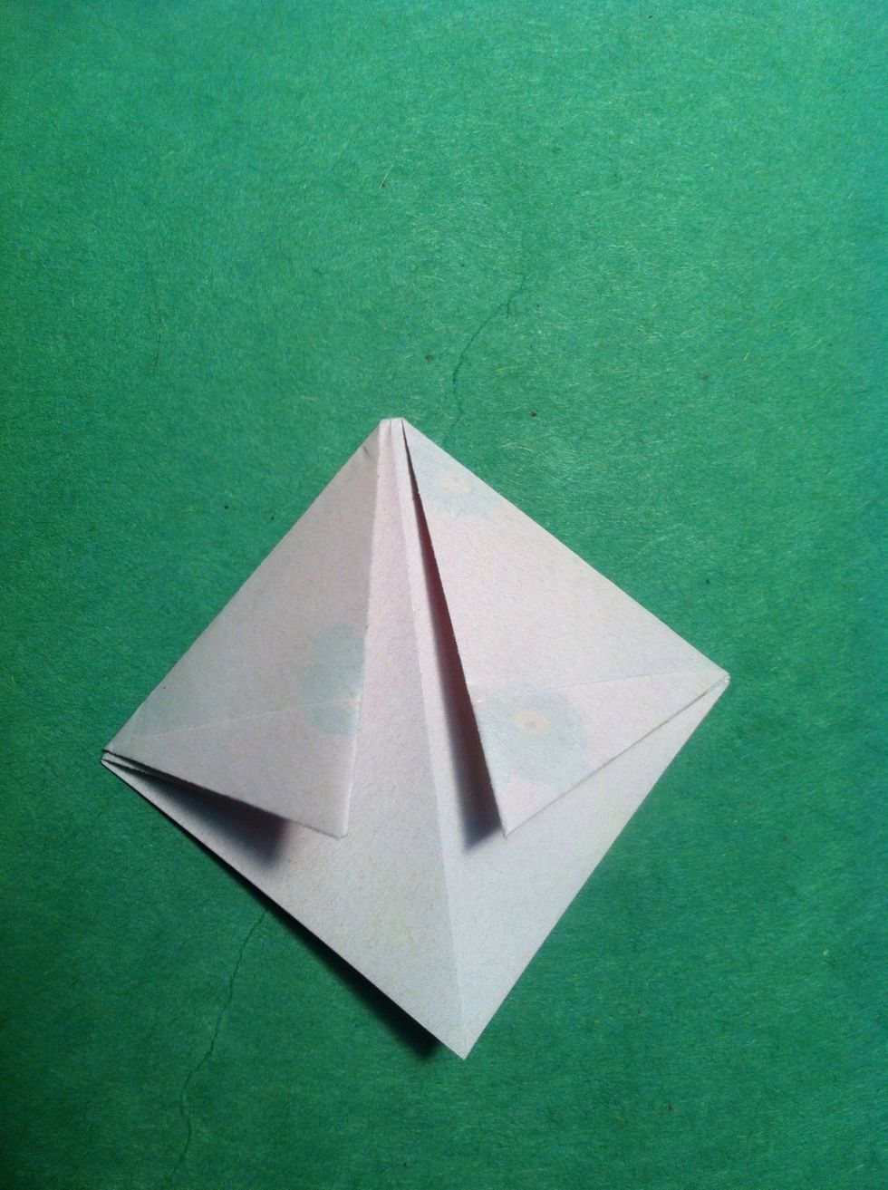 Fold the top corners toward center. Not quite all the way to center crease.