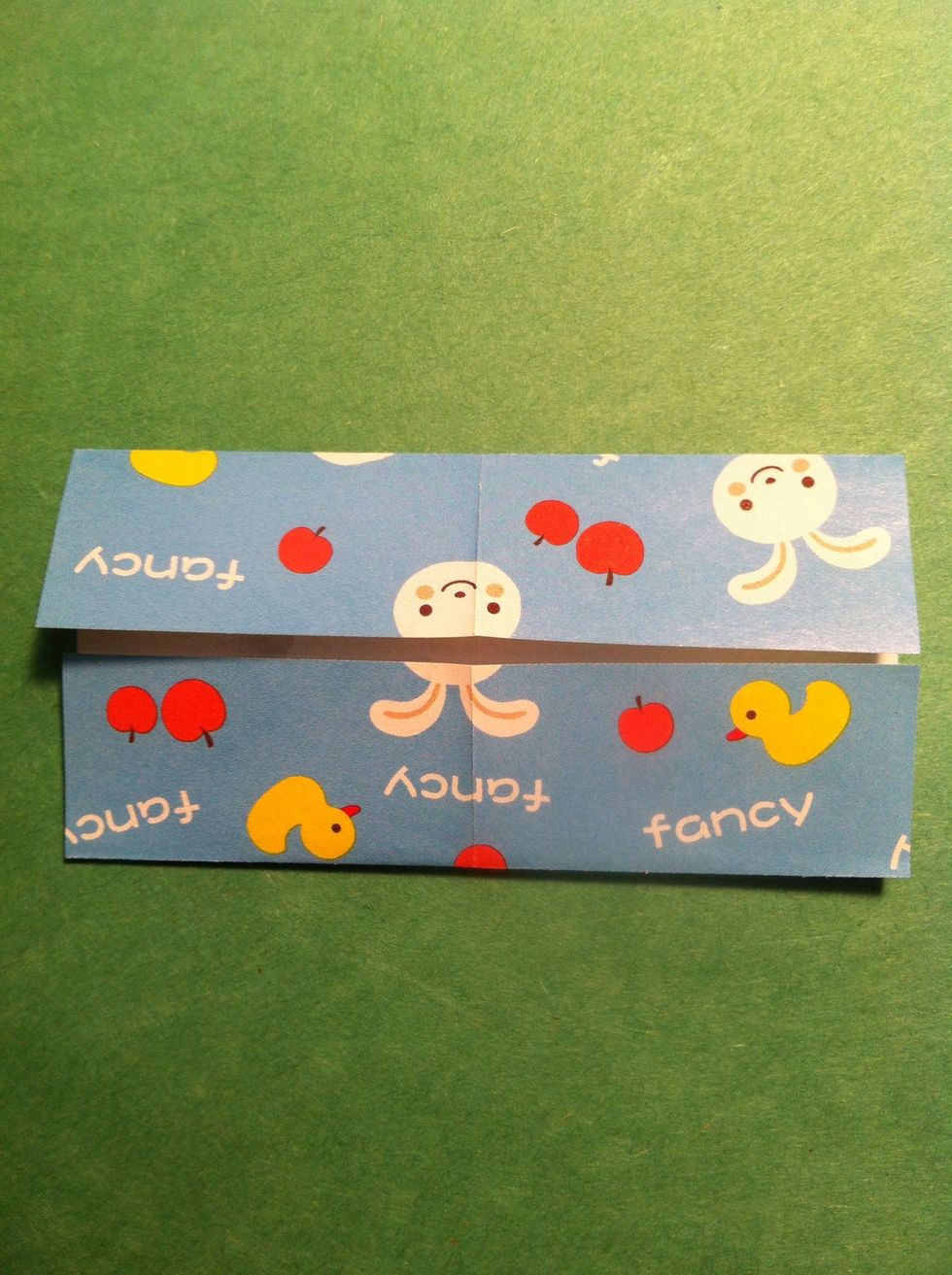 Fold the top edge & the bottom edge to the center crease. Unfold, turn 90 degrees & repeat.