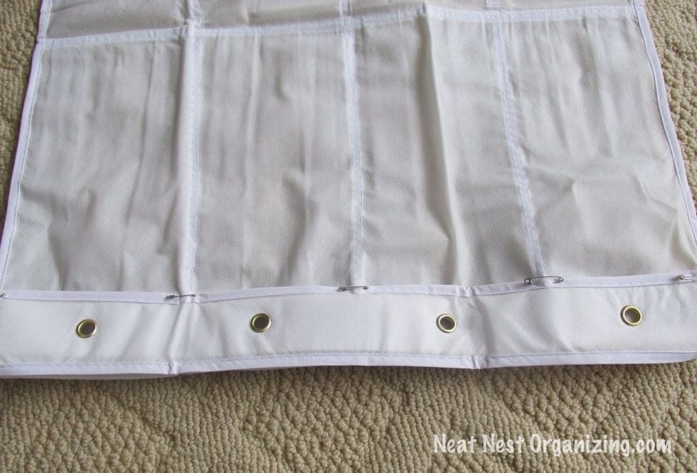 Fold the top flap over and pin it to the back of the organizer. This will create the pocket for the curtain rod.
