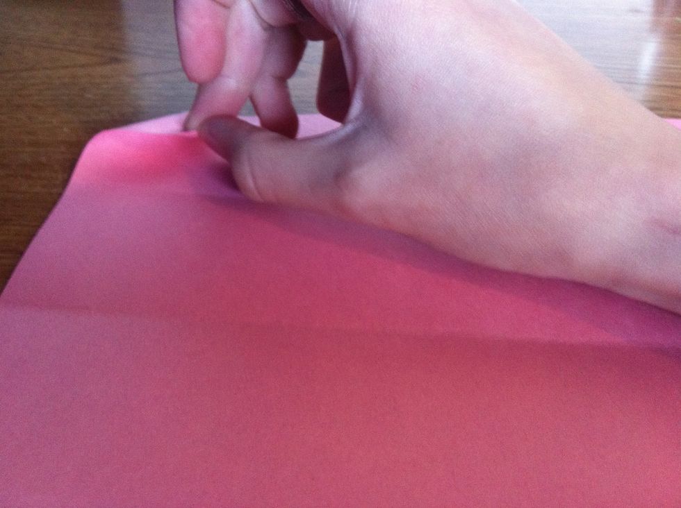 Fold the top left, and bottom right corners.