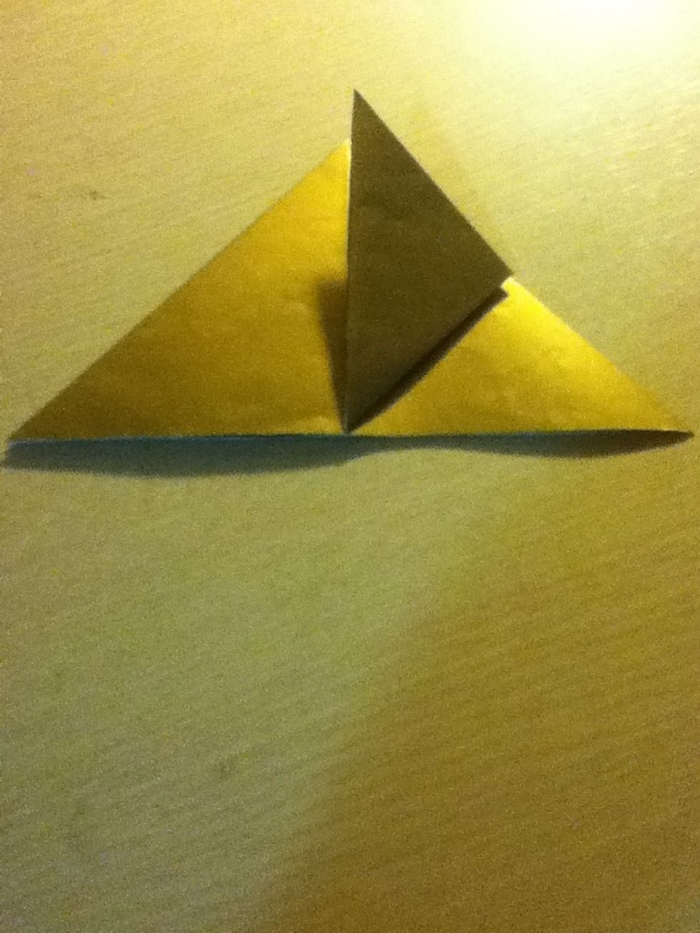 Fold the top most layer corner up to meet the top point