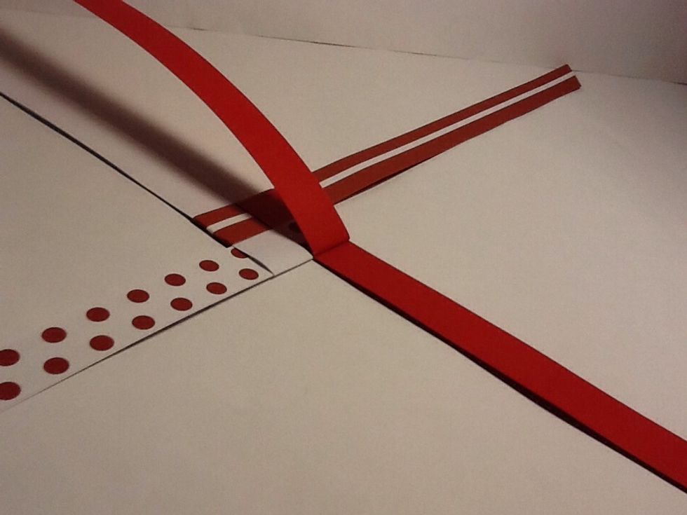 Fold the top of one strip over middle