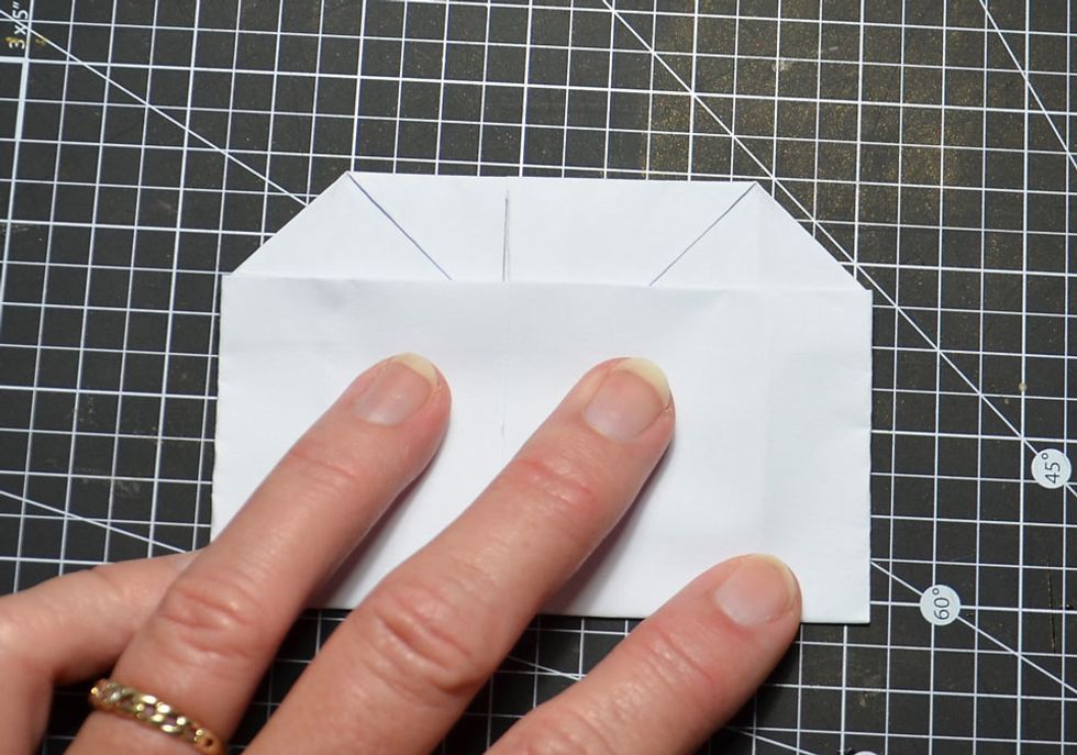 Fold the top of the bag down now to meet the centre of the bottom of the bag as shown.