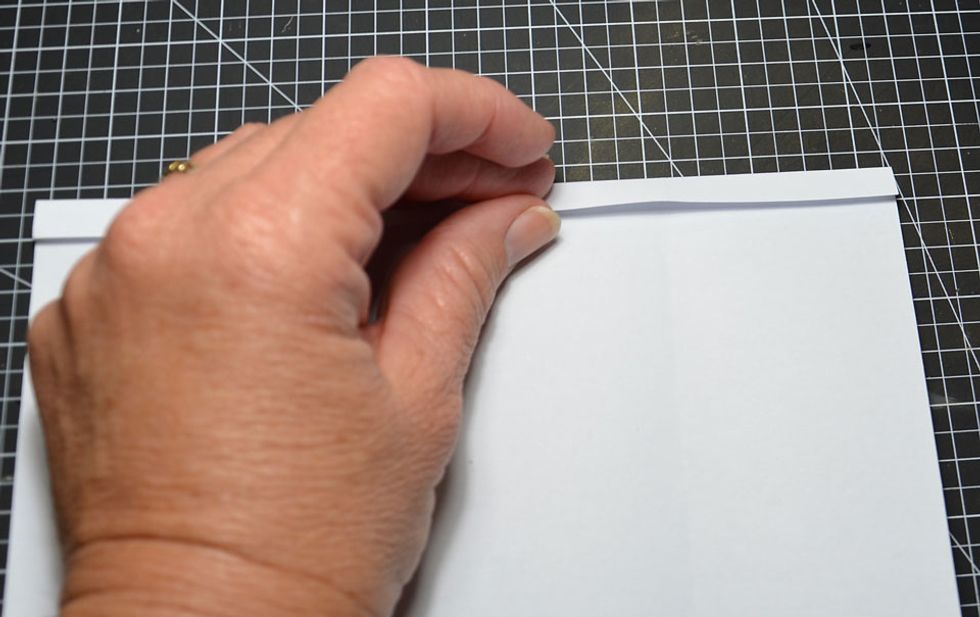 Fold the top of the paper down by about 1cm.