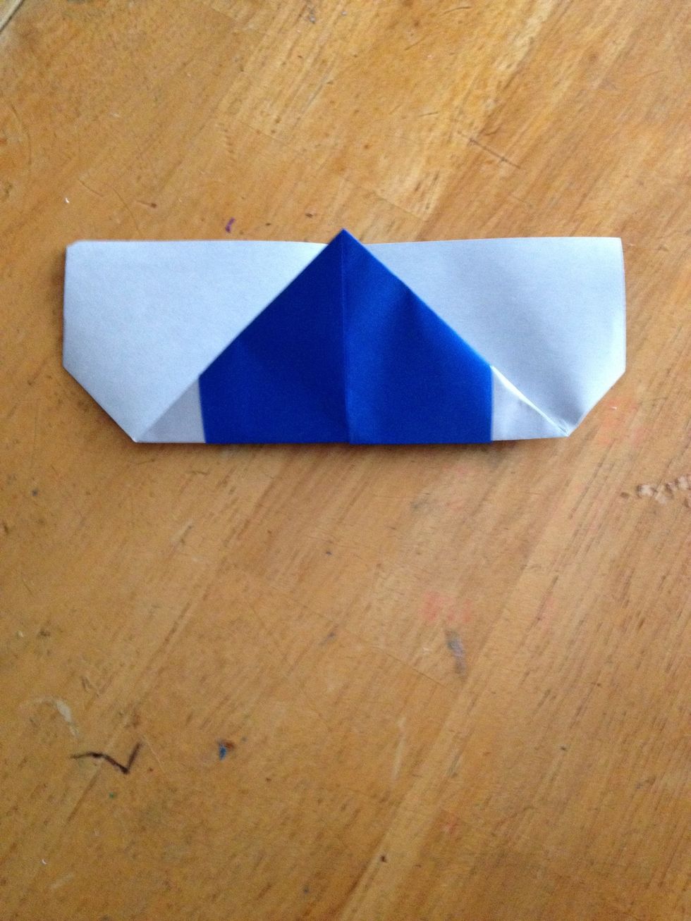 Fold the top pointy end to the bottom.