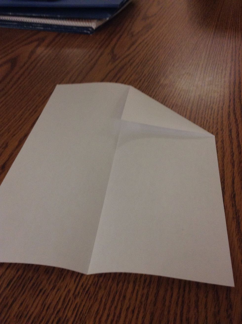 Fold the top right corner to the centre creating a triangle.
