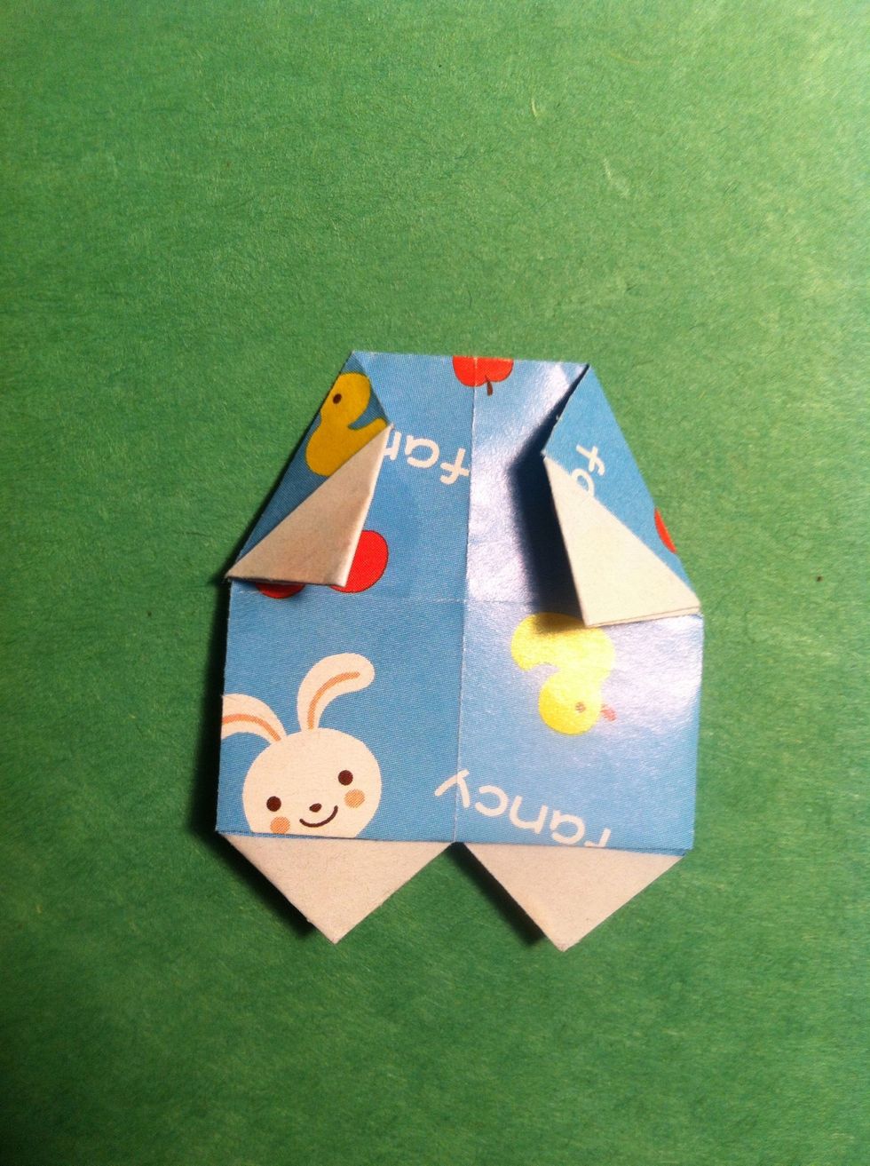 Fold the top right & left corners down as shown. I lost last picture of the body I guess. Refer to the very last pic in guide & fold the tips under on the hands 'n feet. I glued mine. Body is done.