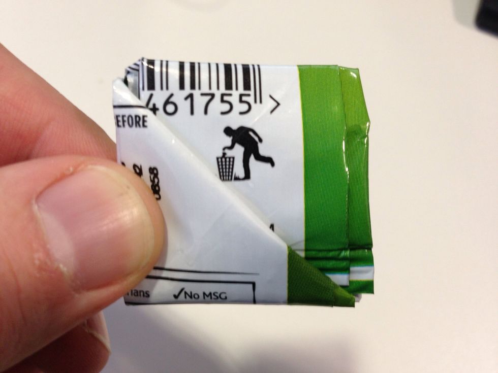 Fold the top section down into the pocket creating a square.