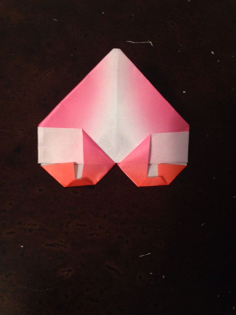 Fold the tops of the corners in