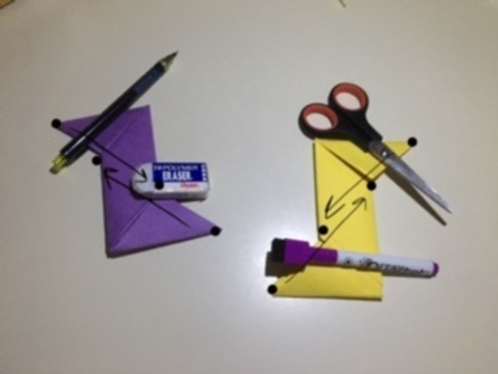 Fold the triangle ends in on both parts so you end up with two rhombuses so that the separation forms two small triangles. It should match the next picture.