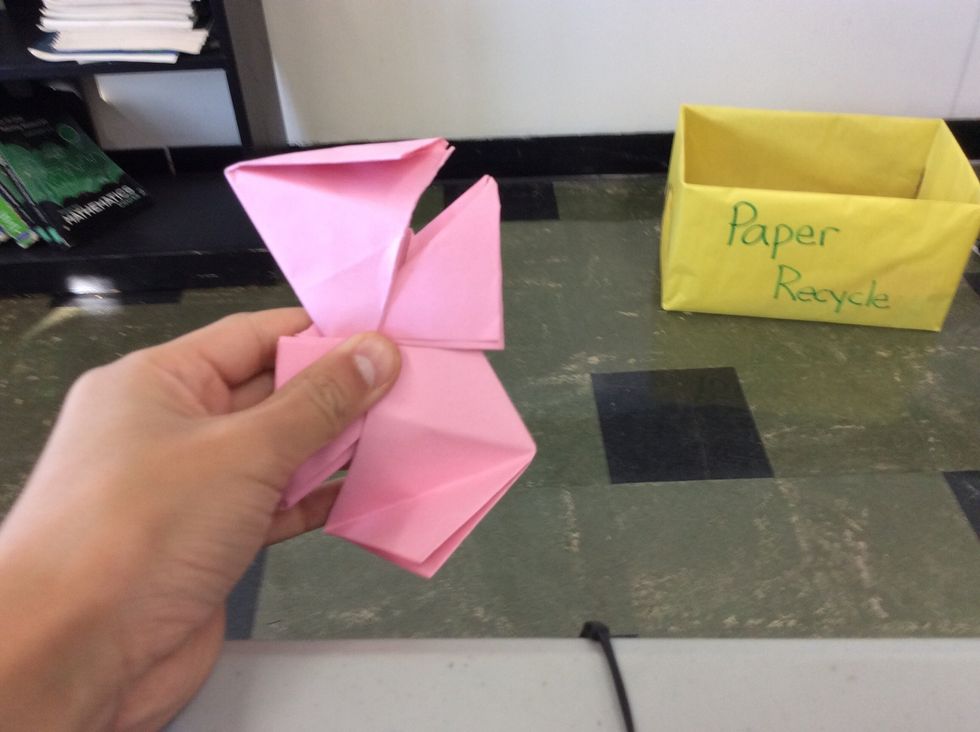 Fold the two flaps from one paper into the cut