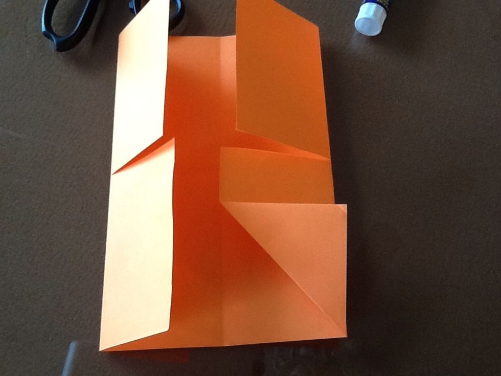 Fold the two inside corners back to the outer edges of each folded side. It will make the four-door book look like a shirt collar. Do the same thing to top edges.