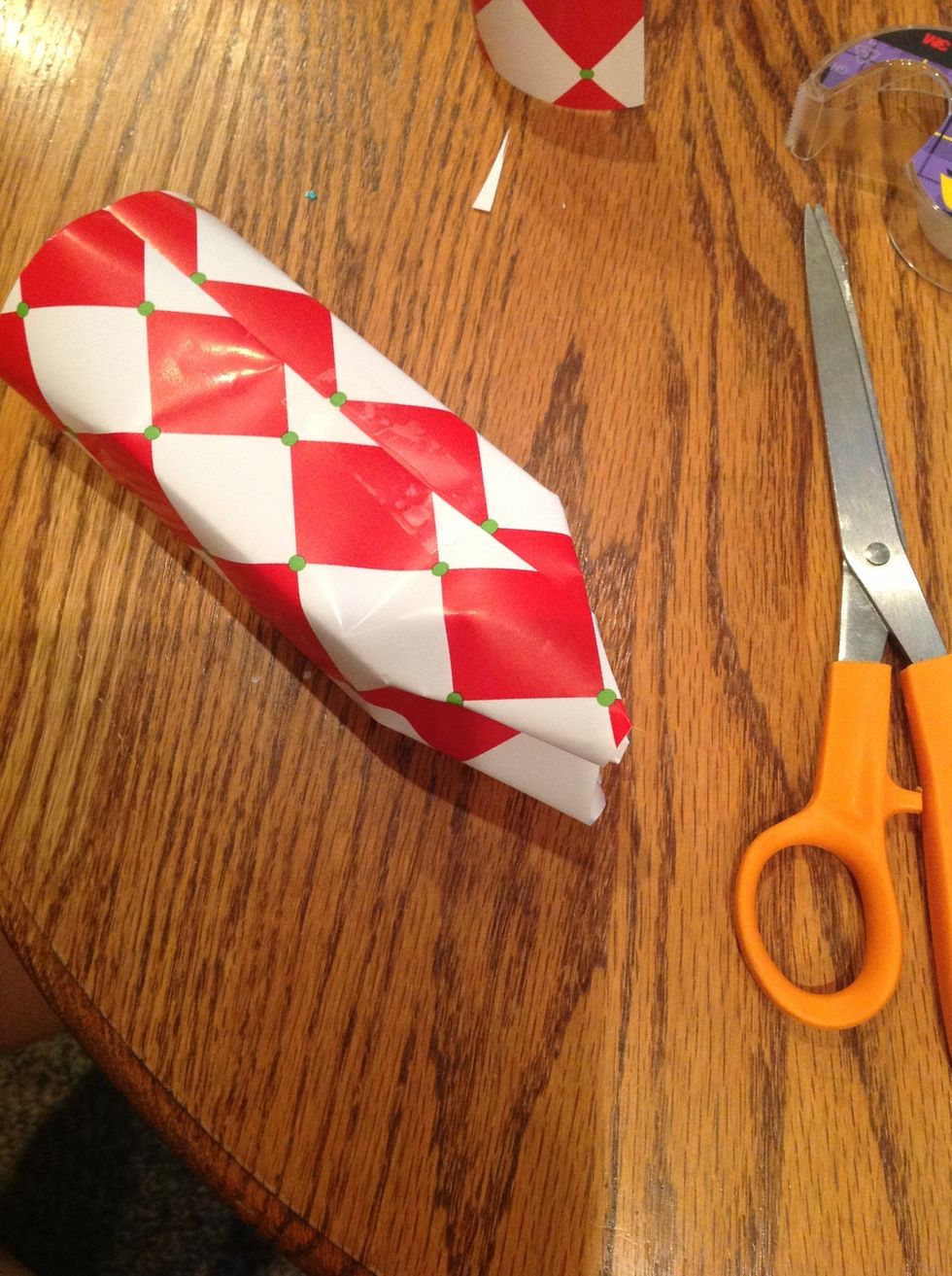 fold the two sides in the middle so it makes two triangles