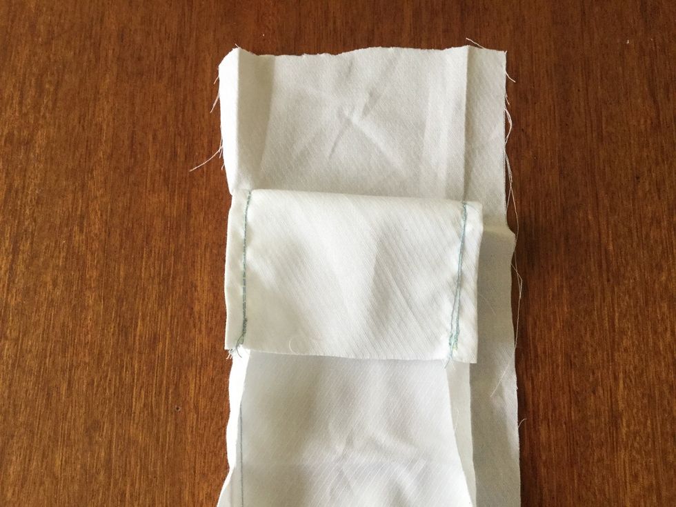 Fold the unstitched seam allowances. This photo shows two seams completed. Complete the other two sides as before. Do this on both bits of material.