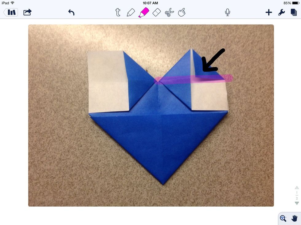 Fold the upper right hand corner to the horizontal fold.