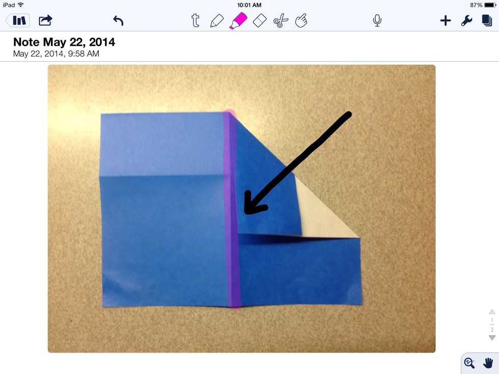 Fold the upper right hand corner to the verticals center line.