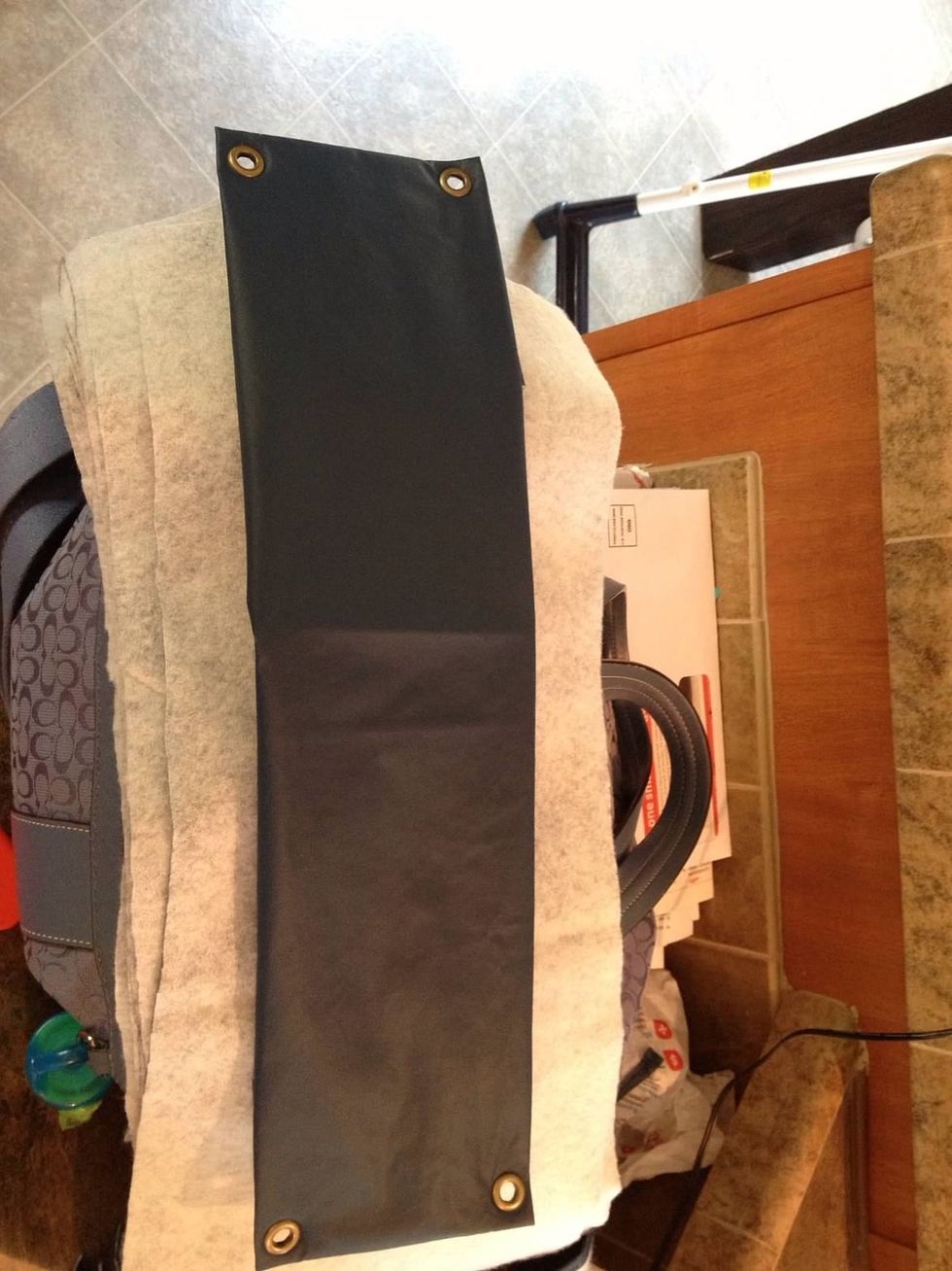 Fold the vinyl around the padding and put eyelets on each corner.