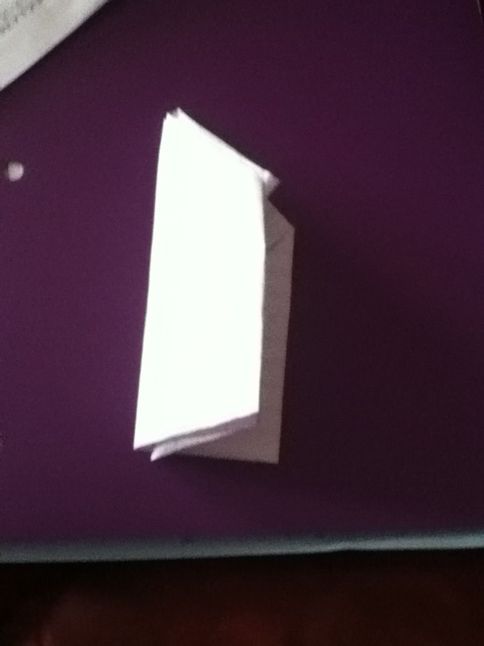 Fold the whole thing in half the vertical way and then unfold and flip over.