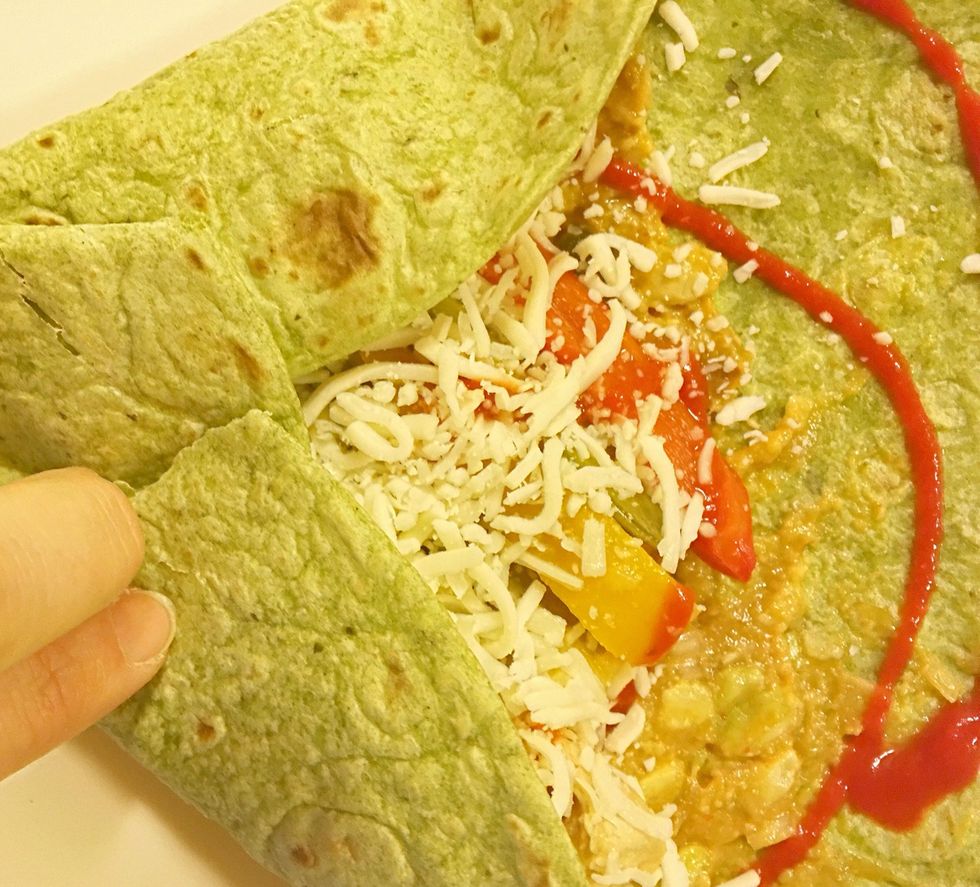 Fold the wrap. Start by folding up an edge and then continue around folding in a piece as you go. The last piece should cover the center. If not it is probably too full.