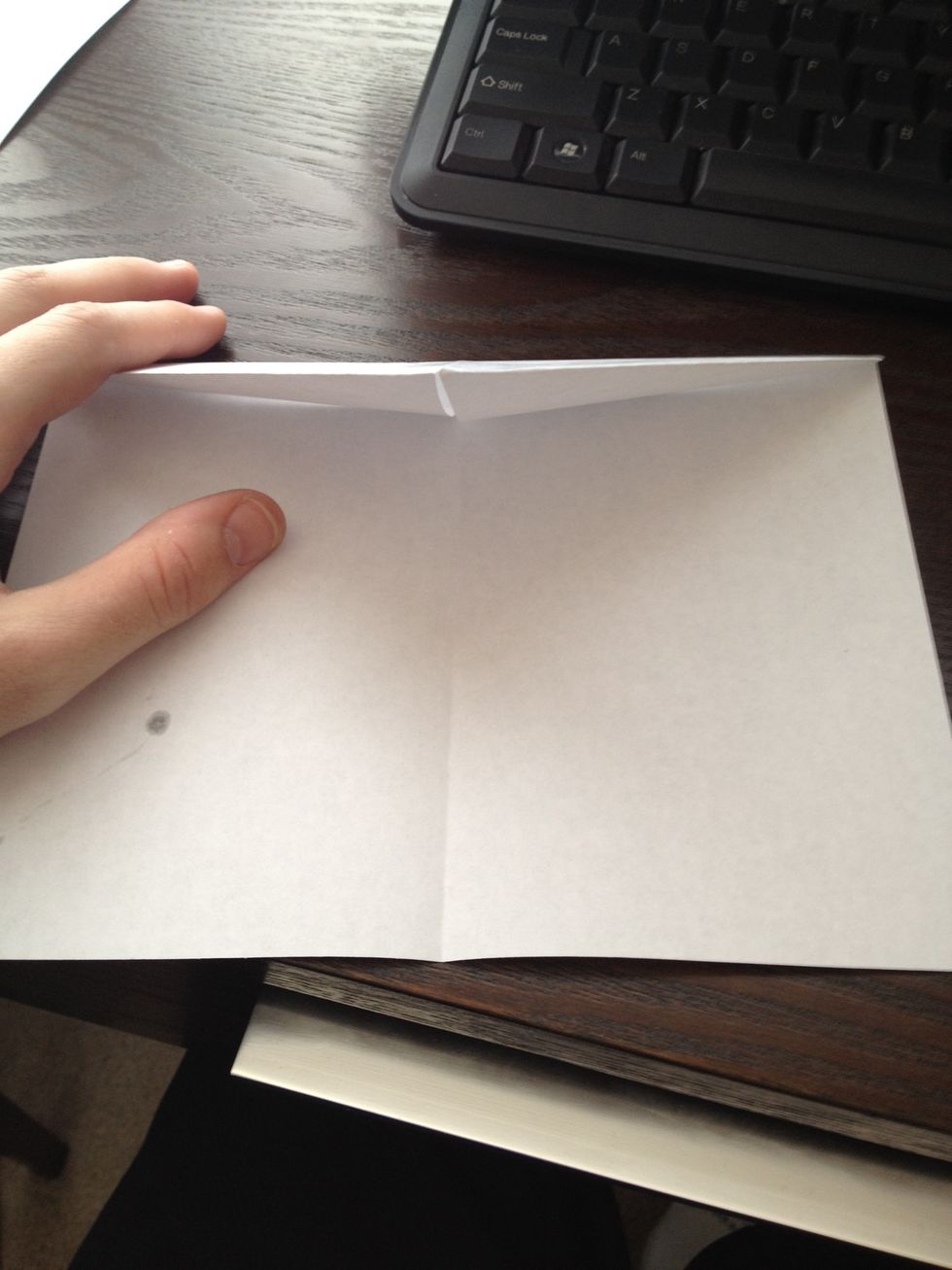 Fold these triangles down the mid half of the paper