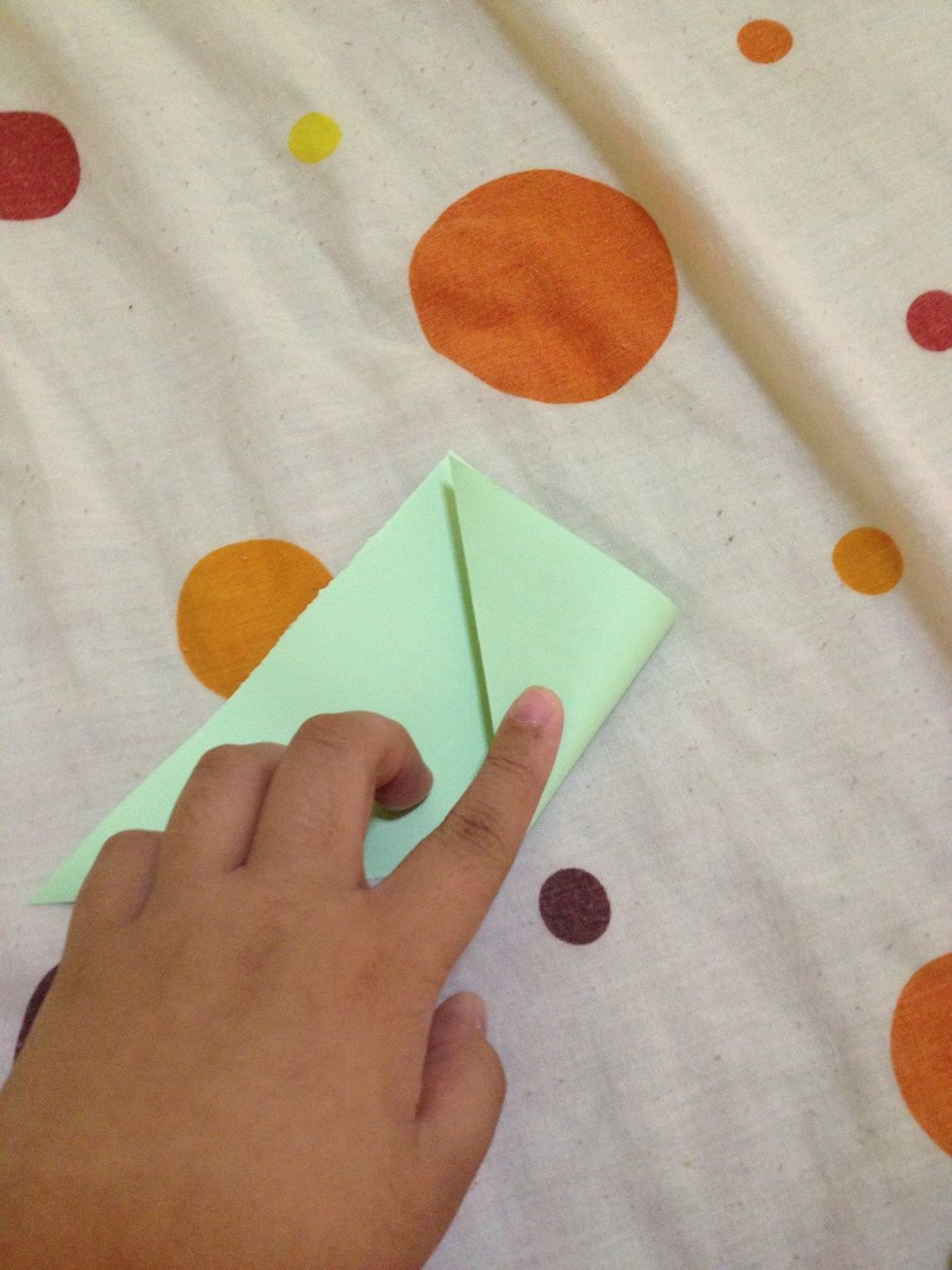 Fold this corner to meet the center. Do the same to the other side.