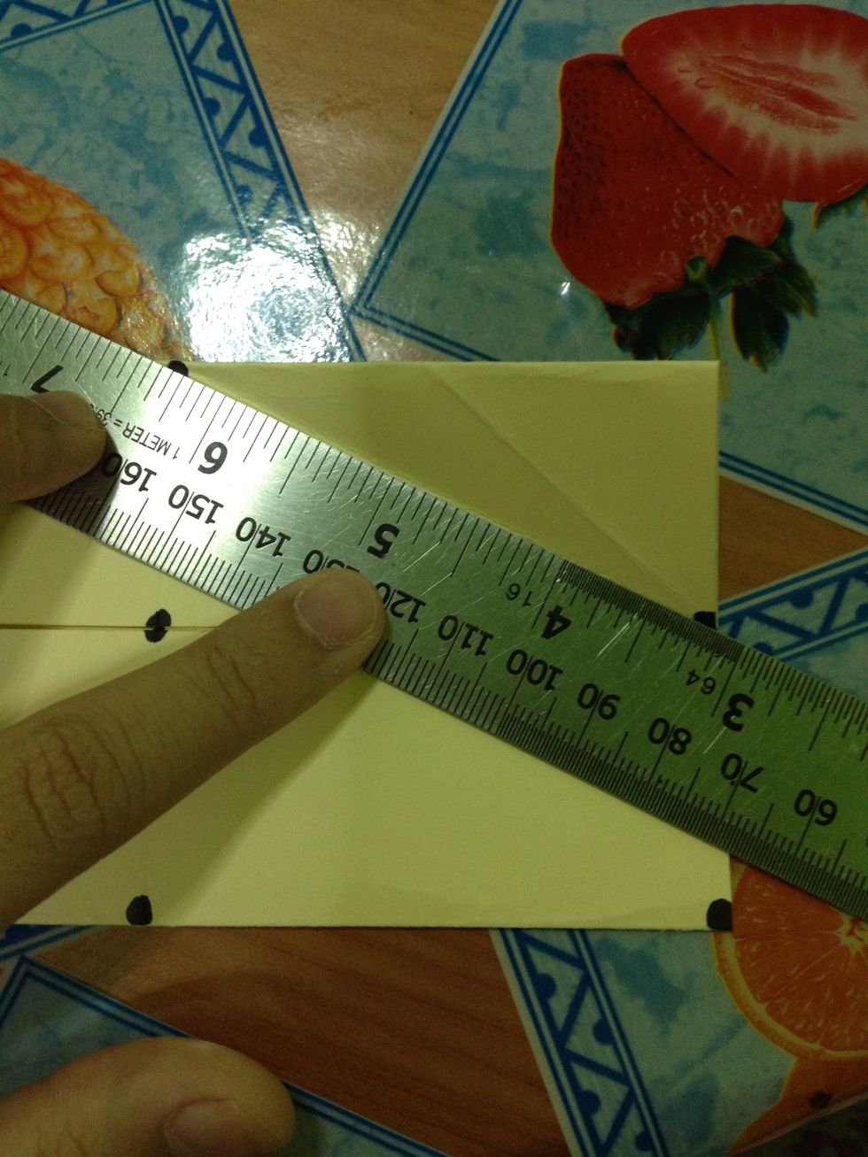 Fold those points with a ruler as your guide. Fold them diagonally.