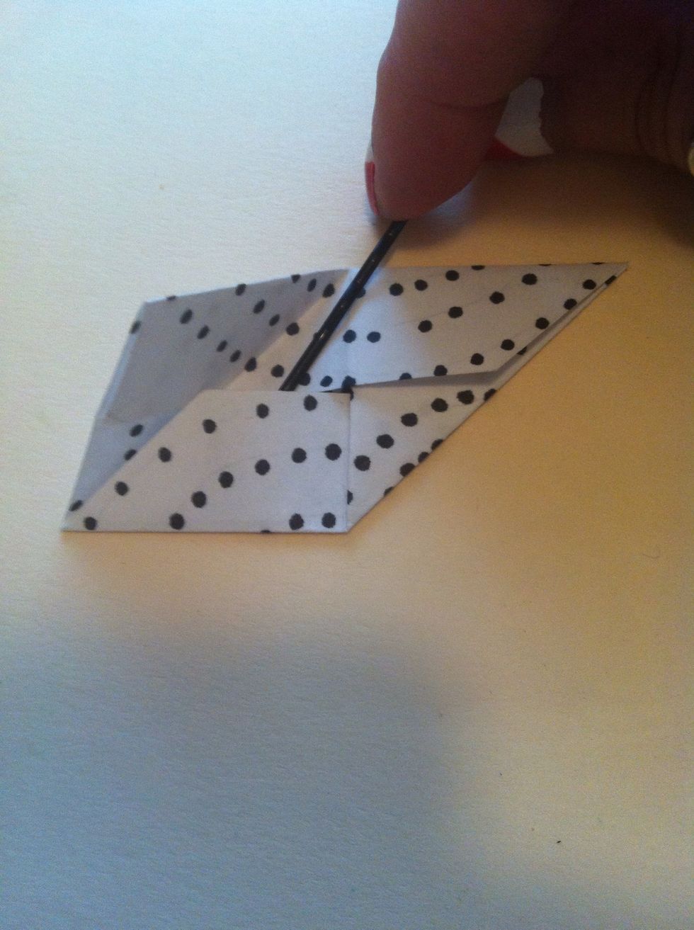 Fold top left corner back down, but this time slide it under into the pocket where bobby pin is showing.