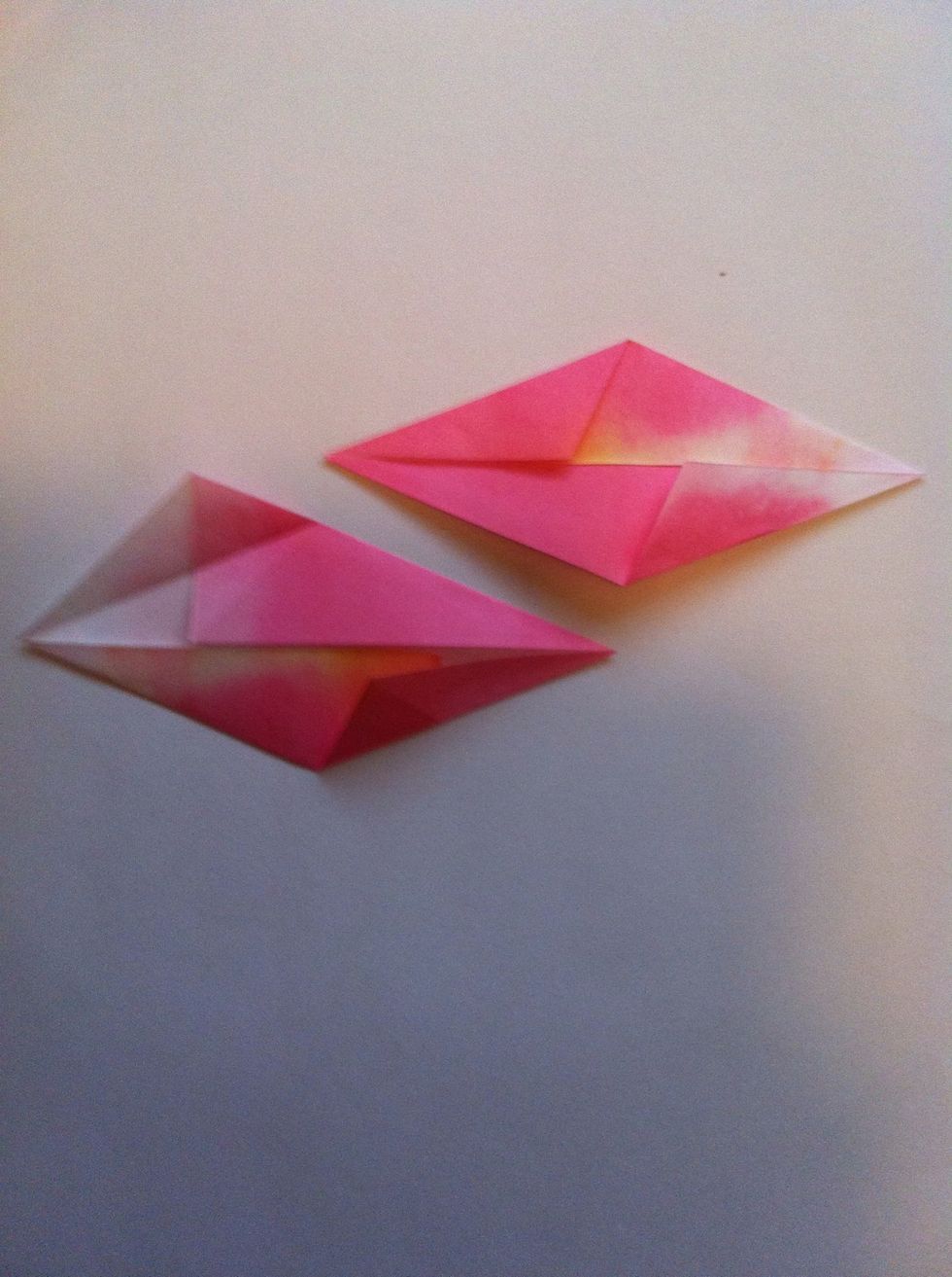Fold top left side to center crease.