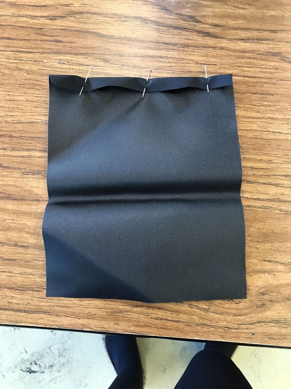 Fold top of pocket over 1/4" and pin in place.