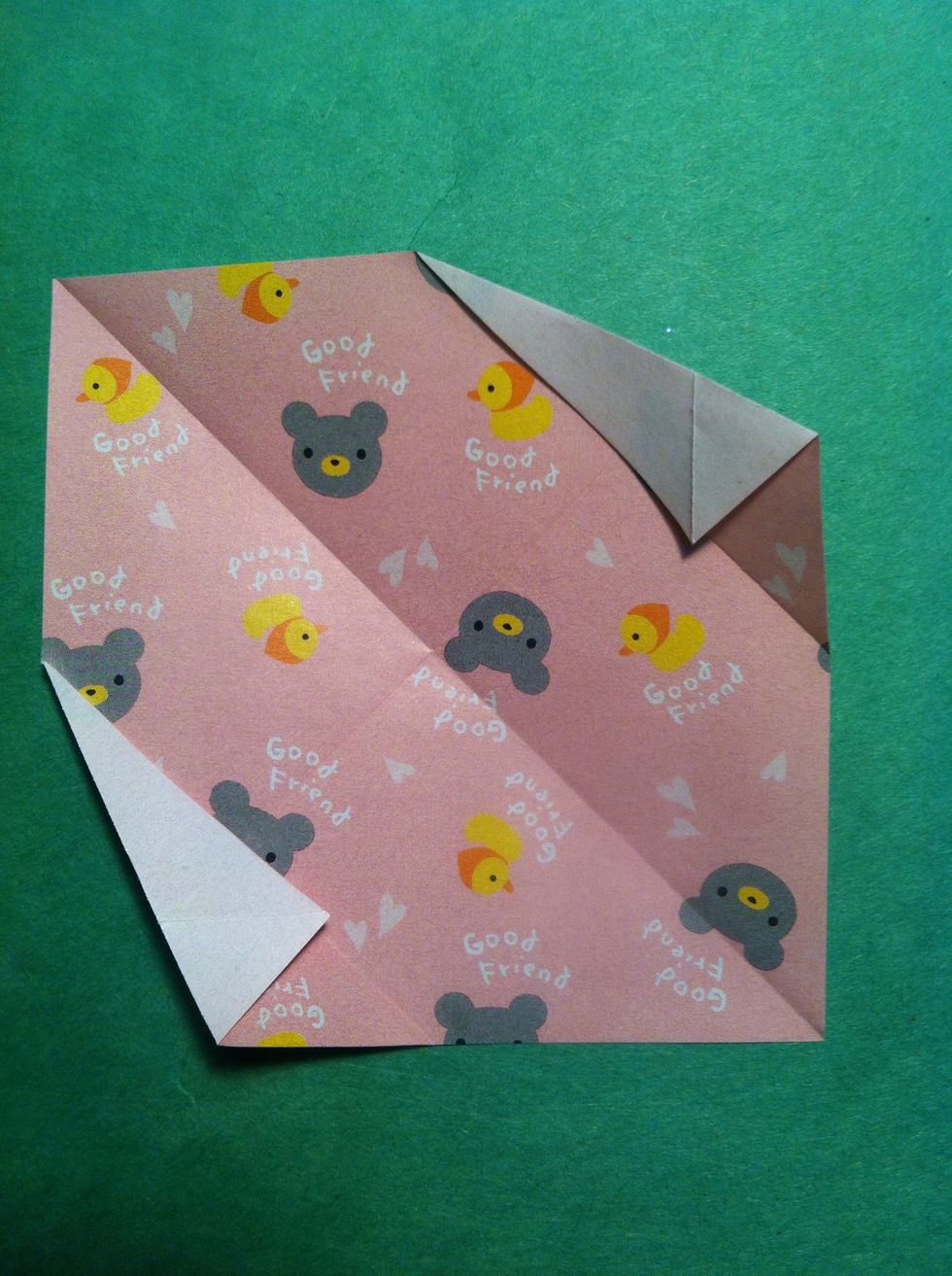 Fold top right corner along the crease you made in previous step. Do the same in bottom.