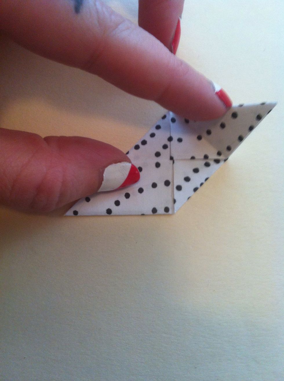 Fold top right tip to bottom point.