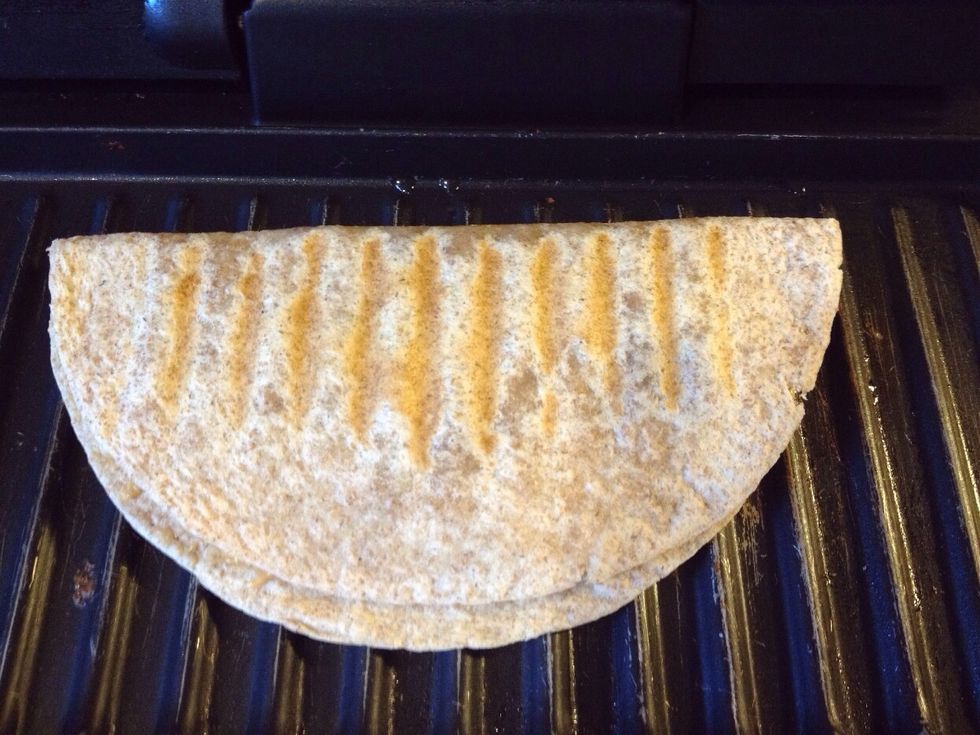 Fold tortilla over and warm on panini press, grill, or frying pan until the chocolate chips melt into the peanut butter.