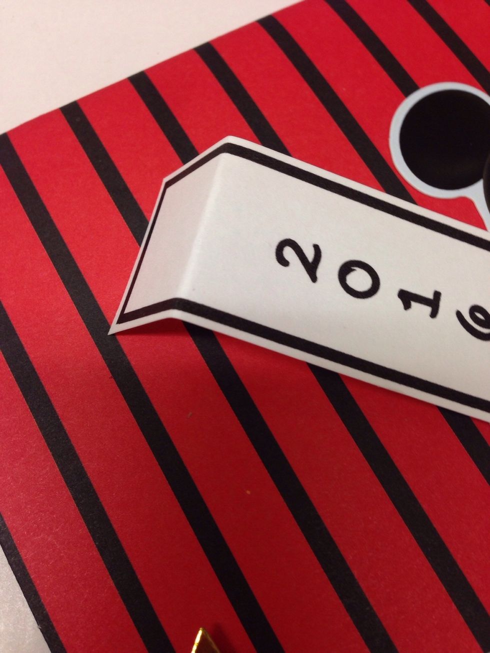 Fold under about 3/4 of an inch on the top of the banner.