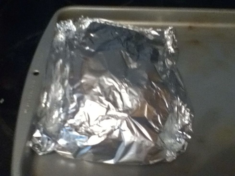 Fold up first lengthwise and then rolling up the sides to make a sealed packet and put it in the oven for 90 minutes to two hours.