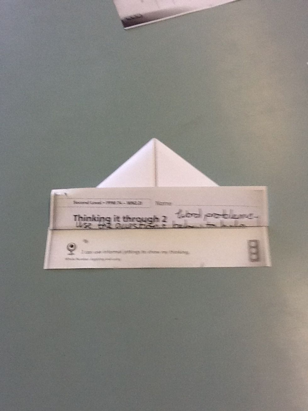 Fold up one side of the paper over the corners like has been done on the picture