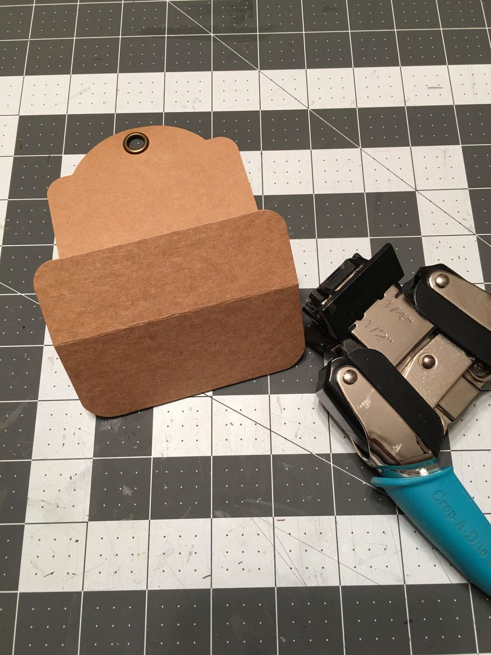 Fold up the tag as shown and use a 1/2 inch corner rounder to punch the corners of the bottom fold.