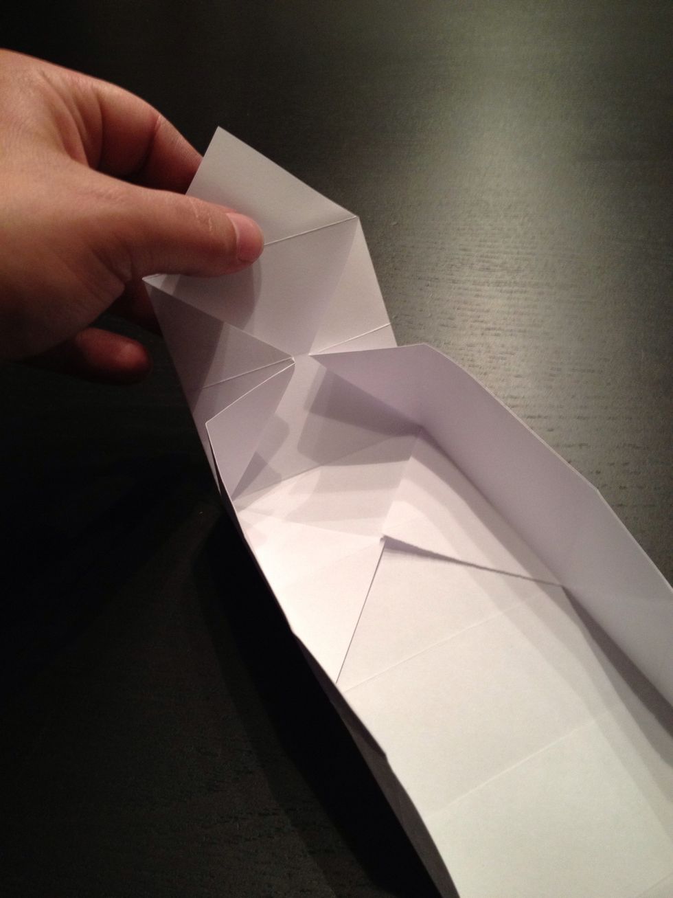 Fold up the upper part, the edges should fold into a triangle almost by themselves.