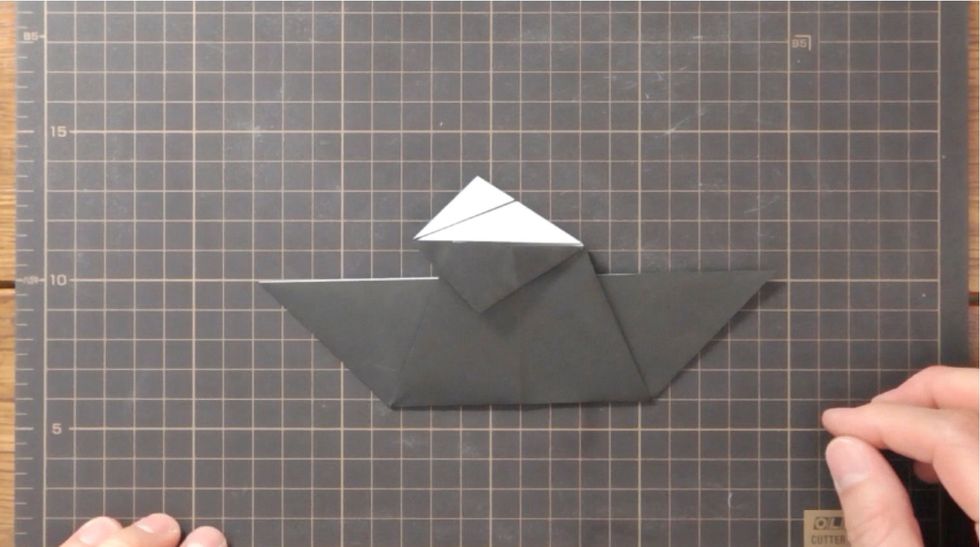 Fold upper and lower folded edges to the left to meet at center line.