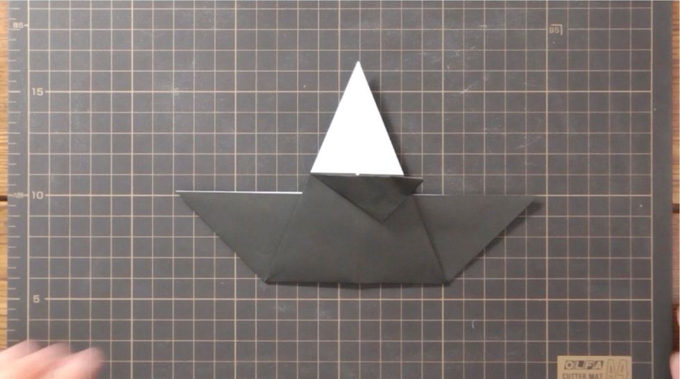 Fold upper and lower folded edges to the right to meet at center line.