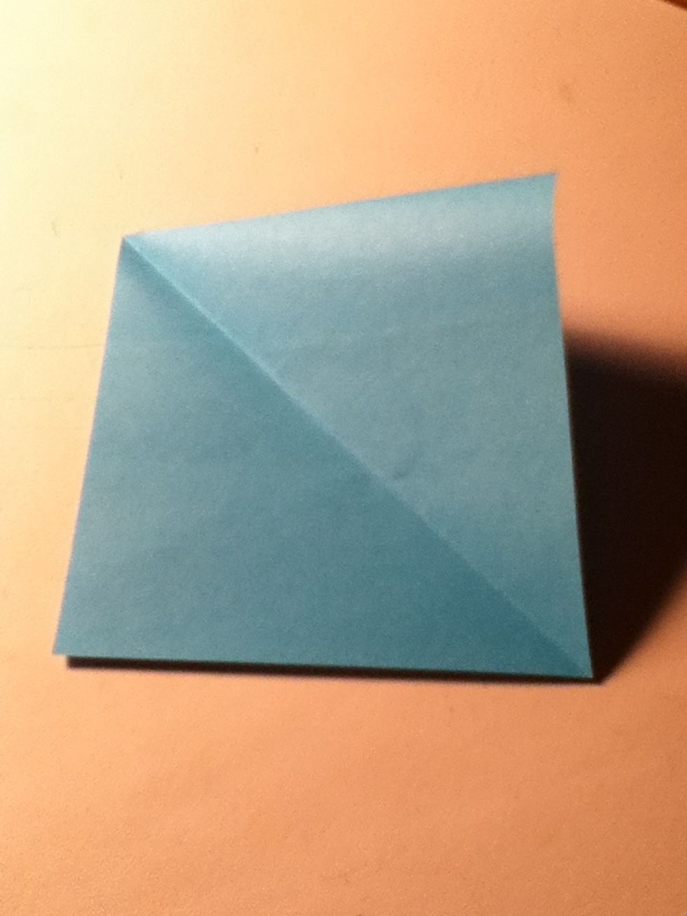 Fold upper right corner to bottom left corner