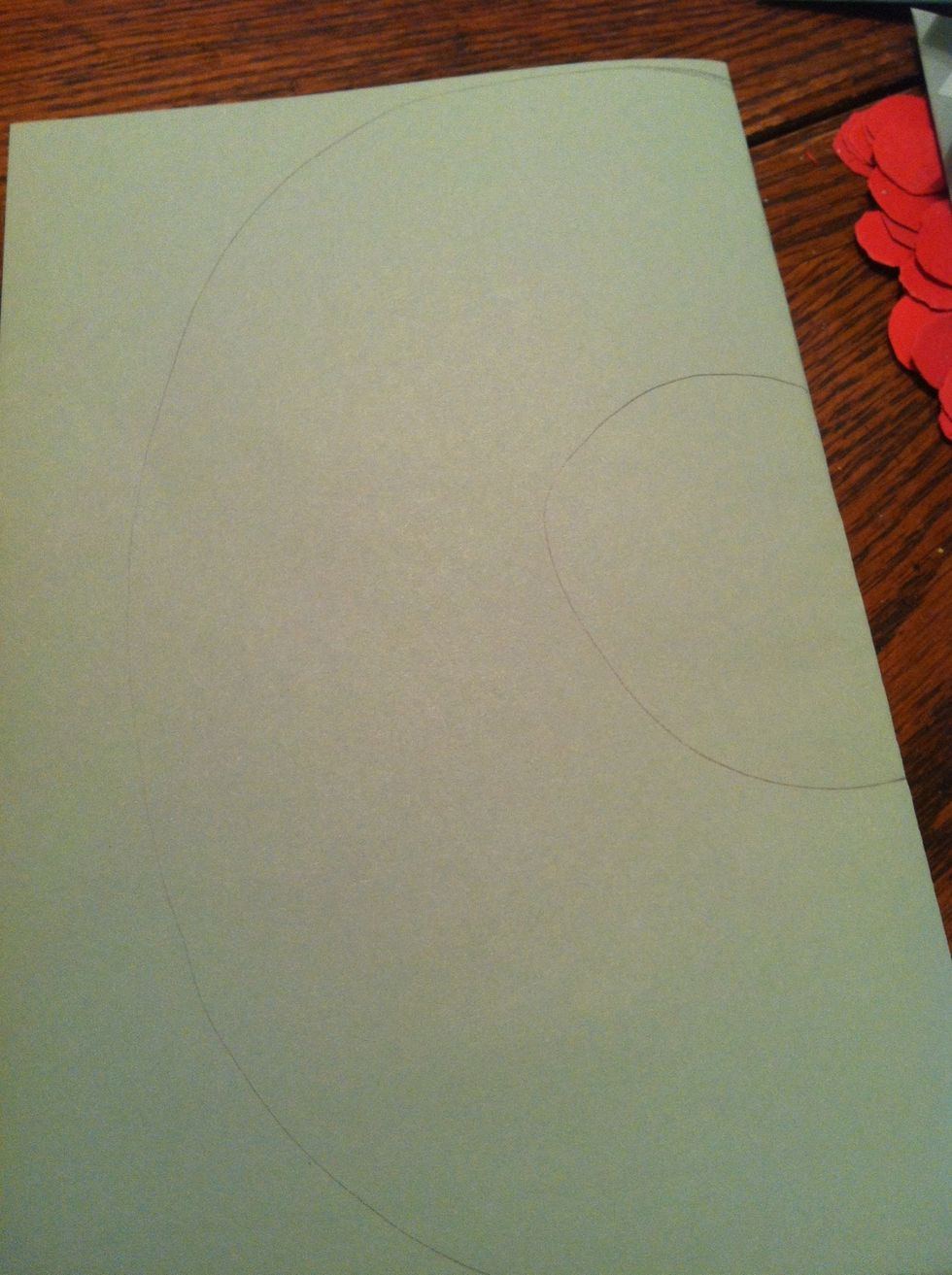 Fold you green paper in half and draw two half circles as guides. Make sure it isn't too big or it'll be an oval shape when cut.