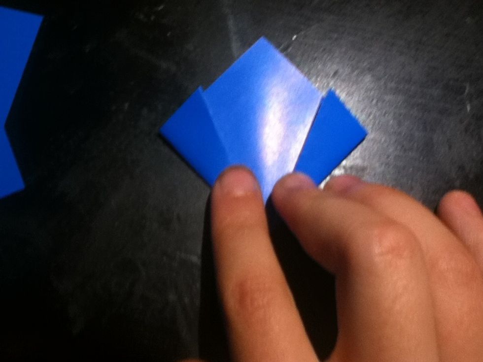 Fold your flattened parts inward on the previously made crease.