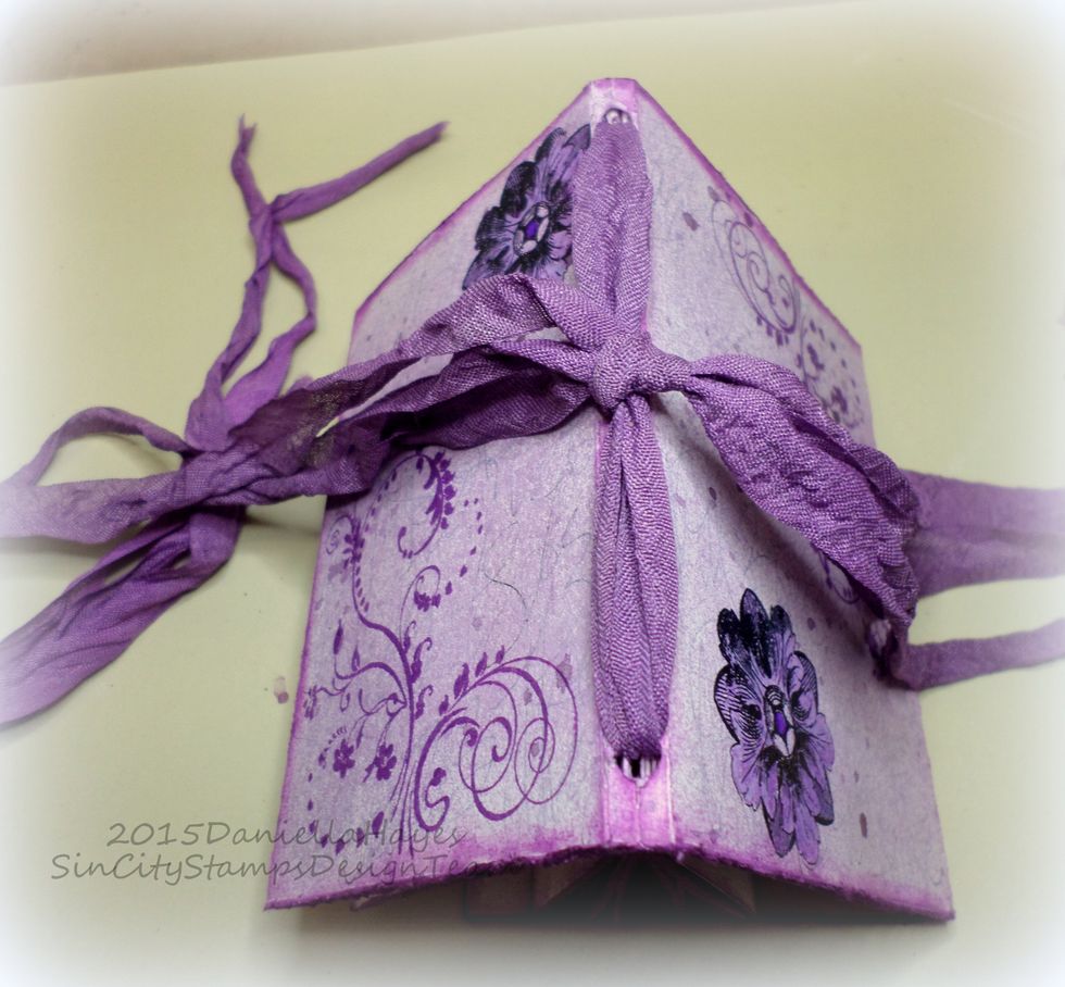 Fold your journal into itself to cover the pages and tie a bow on the side opposite the spine. See the ribbon on the right and left? Tie them together to close the journal.