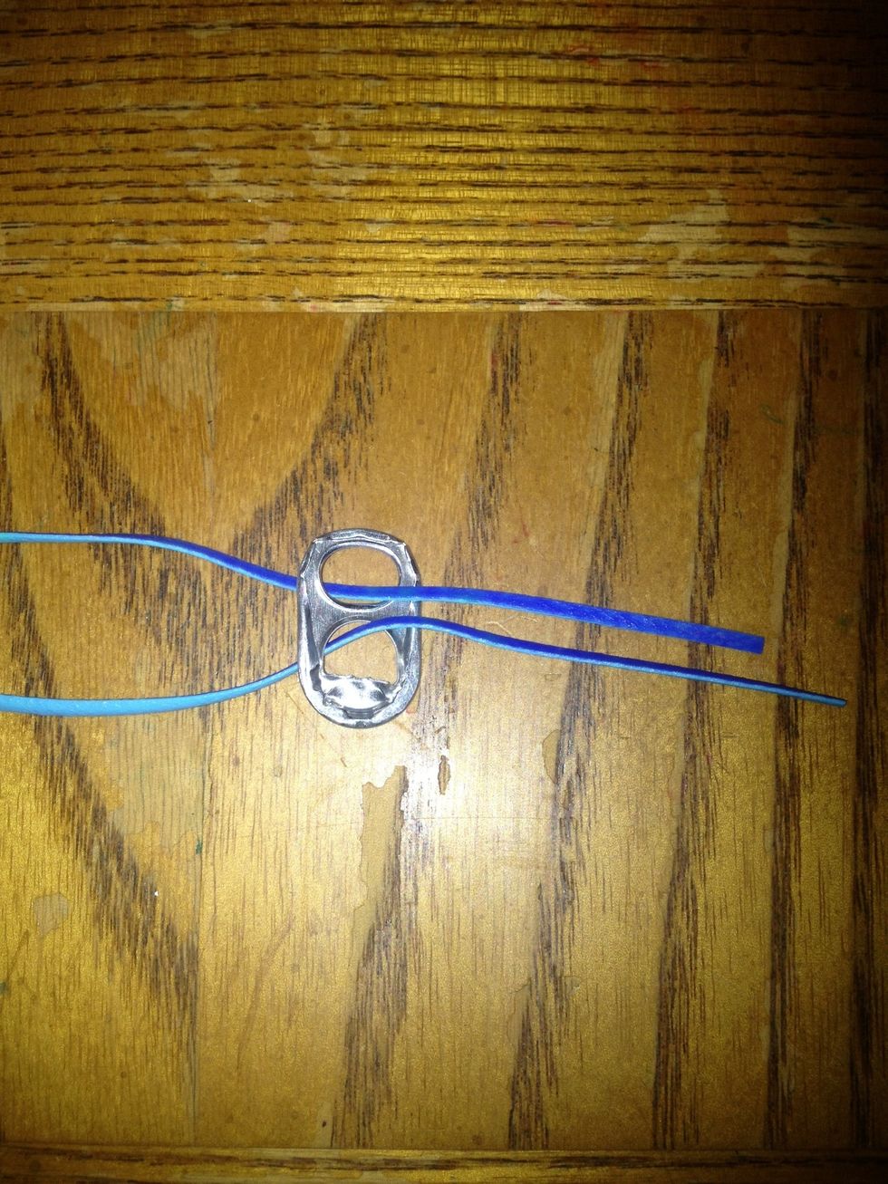 Fold your lace in half and stick both ends through the soda tab. Face your soda tab rough side up.